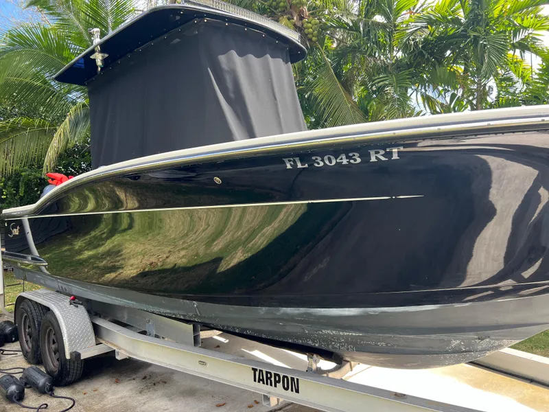 Slide: The Image of 2019 Scout 255LXF boat on a Tarpon trailer, side view with registration number FL 3043 RT. - 17