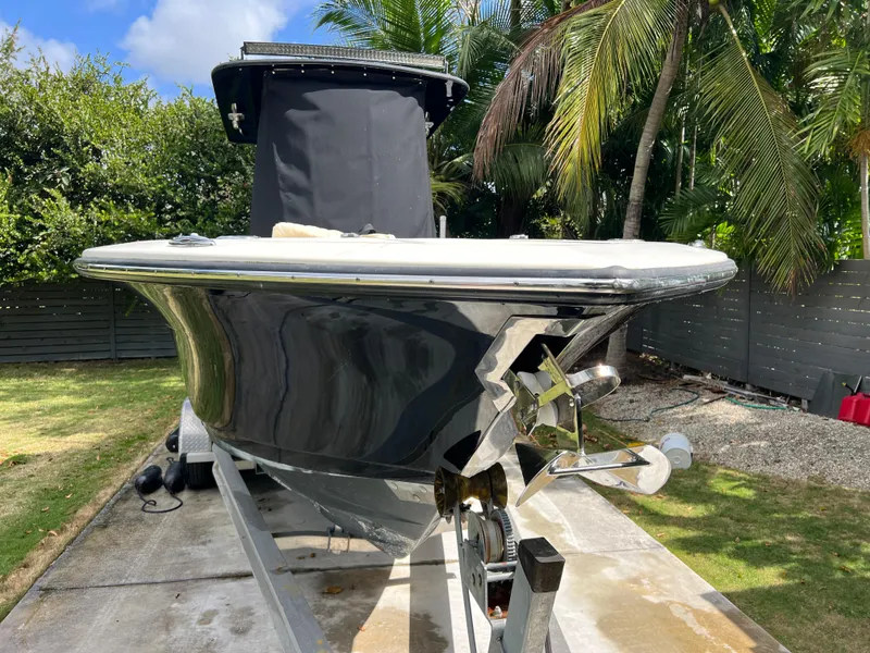 Slide: The Image of 2019 Scout 255LXF boat on trailer in tropical setting. - 18