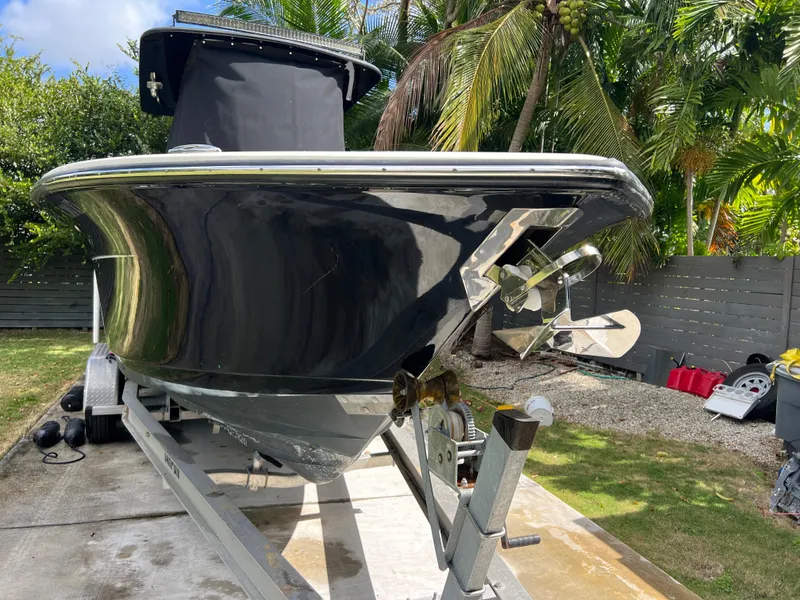 Slide: The Image of 2019 Scout 255LXF boat on trailer in tropical setting. - 19