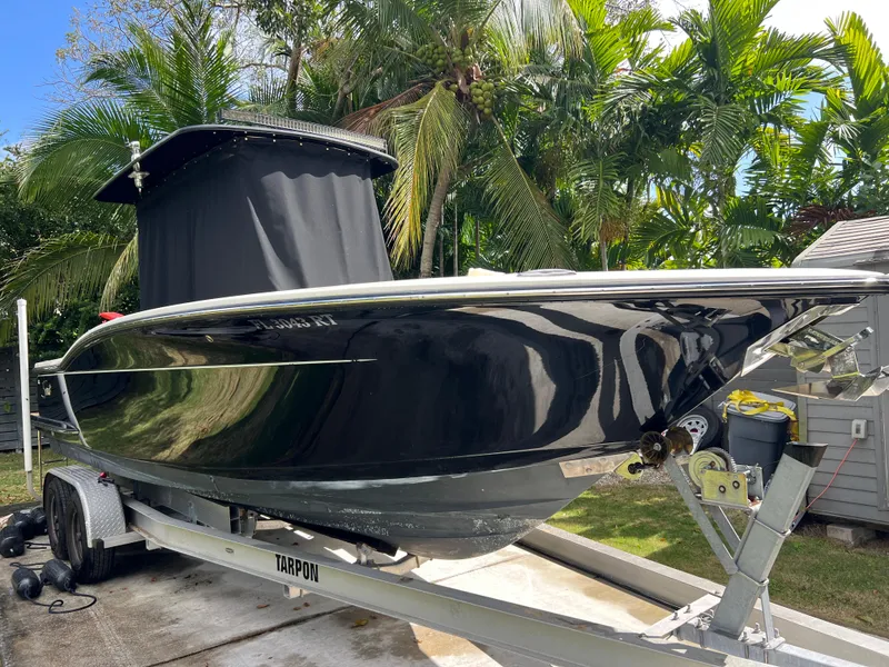 Slide: The Image of 2019 Scout 255LXF boat on trailer with lush tropical background. - 20