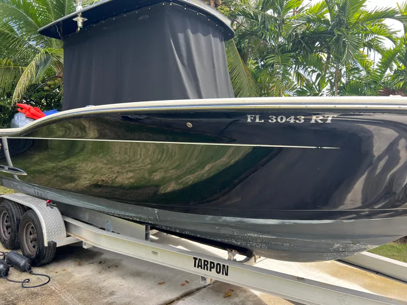 Slide: The Image of 2019 Scout 255LXF boat on a Tarpon trailer, side view. - 24