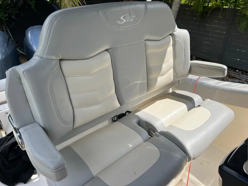 Slide: The Image of 2019 Scout 255LXF boat with gray and white cushioned seating. - 32