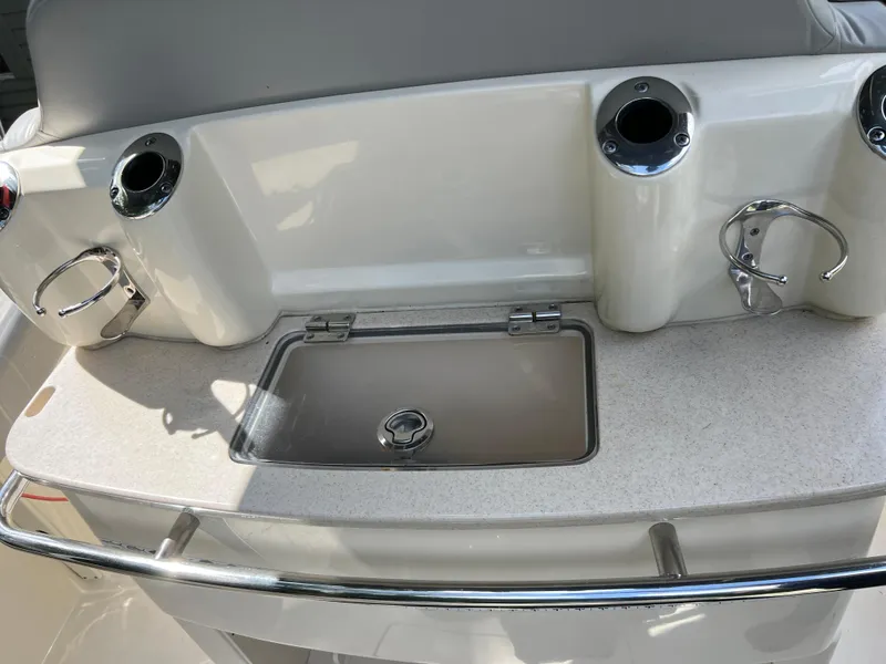 Slide: The Image of 2019 Scout 255LXF boat with fishing rod holders and a built-in sink. - 34