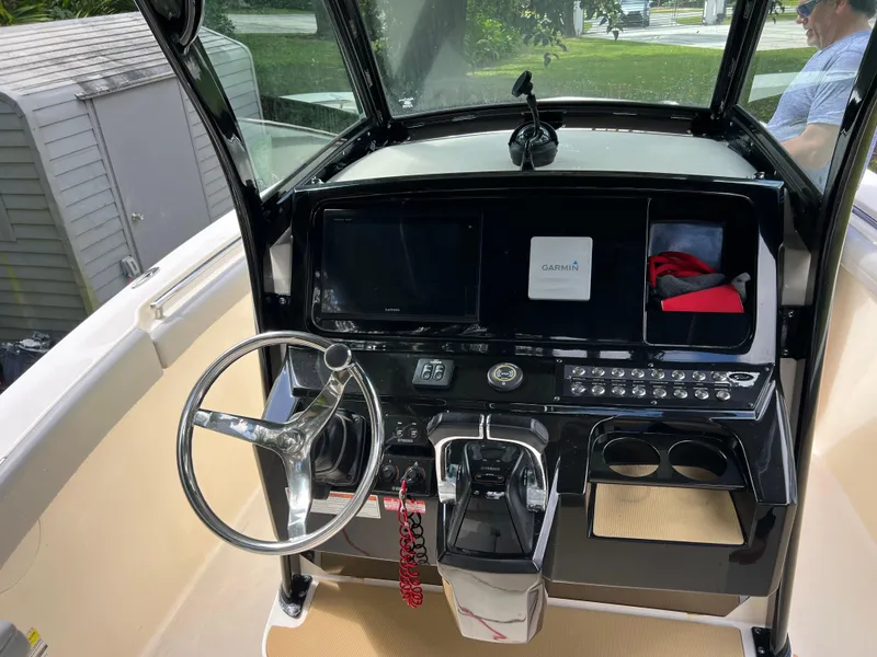 Slide: The Image of 2019 Scout 255LXF boat dashboard with steering wheel and control panel. - 36