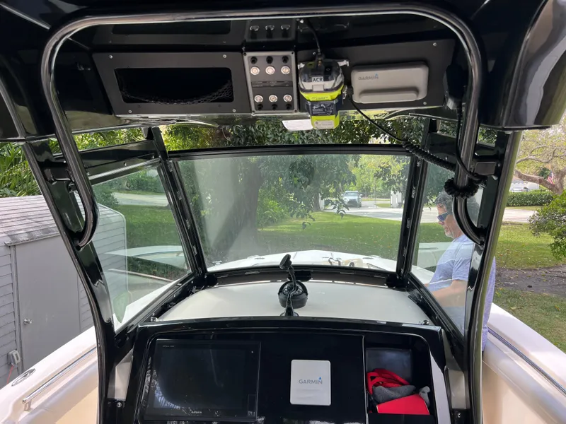 Slide: The Image of 2019 Scout 255LXF boat dashboard with navigation equipment and controls. - 37