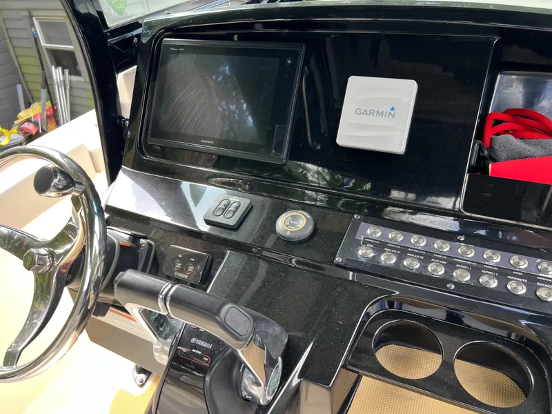 Slide: The Image of 2019 Scout 255LXF boat dashboard with Garmin navigation system and steering wheel. - 38
