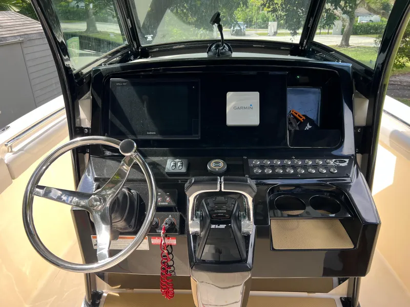 Slide: The Image of 2019 Scout 255LXF boat dashboard with steering wheel and Garmin navigation system. - 41