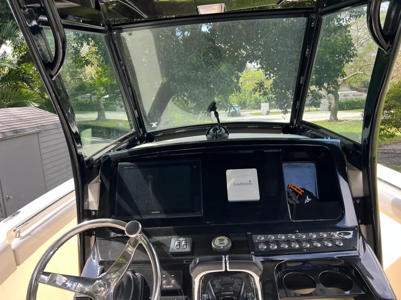 Slide: The Image of 2019 Scout 255LXF boat dashboard with Garmin navigation system and steering wheel. - 42