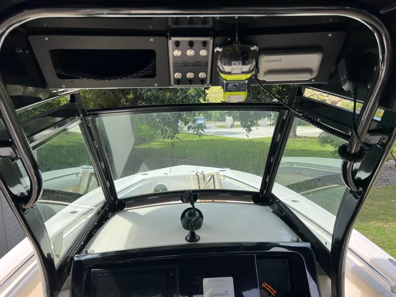 Slide: The Image of 2019 Scout 255LXF boat cockpit with navigation equipment and windshield. - 43