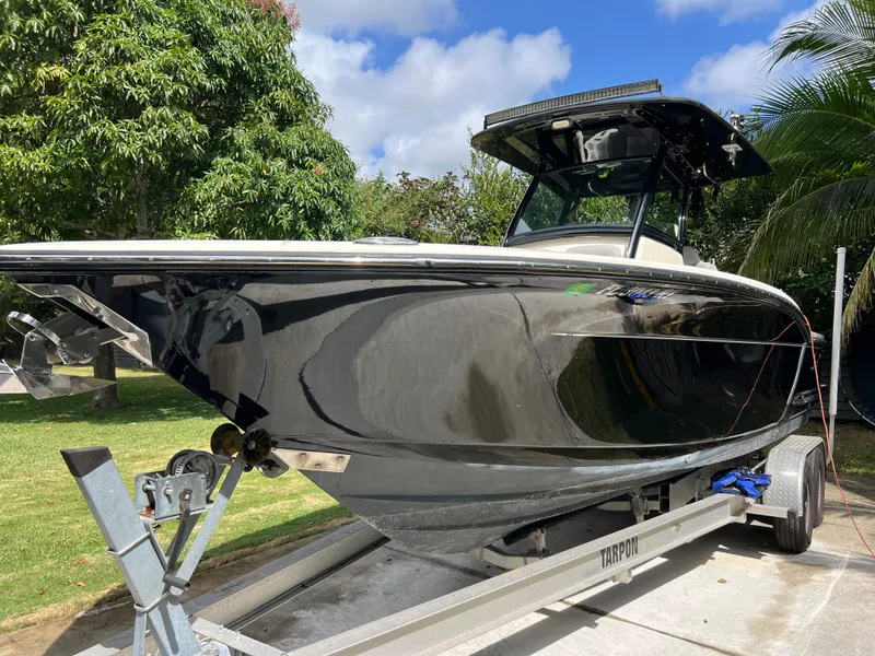 Slide: The Image of 2019 Scout 255LXF boat on trailer, side view. - 7