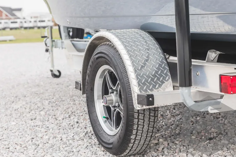 Slide: The Image of 2023 Tidewater 1910 Bay Max boat trailer wheel and fender on gravel. - 13