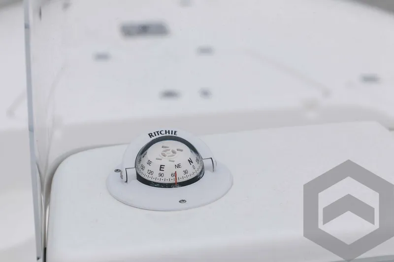 Slide: The Image of Close-up of a Ritchie compass on a 2023 Tidewater 1910 Bay Max boat. - 32