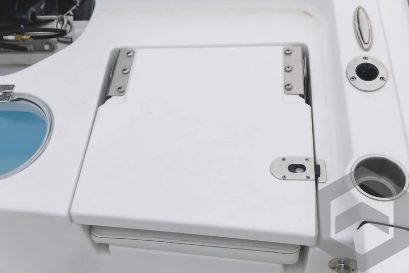 Slide: The Image of 2023 Tidewater 1910 Bay Max boat deck with storage compartment and fishing rod holders. - 43