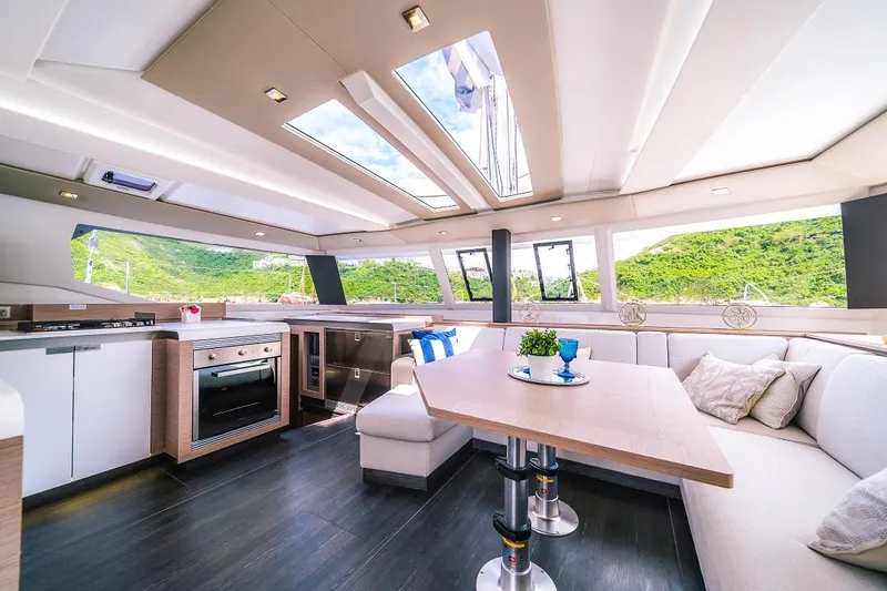 Slide: The Image of Luxurious interior of 2024 Fountaine Pajot Tanna 47 catamaran with modern kitchen and seating area. - 16