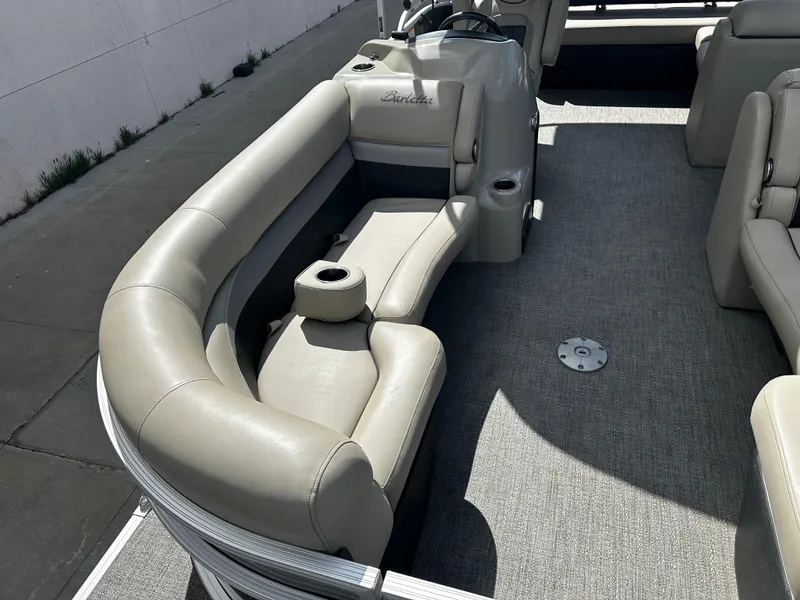 Slide: The Image of 2021 Barletta C22U pontoon boat interior with beige seating and carpeted floor. - 12