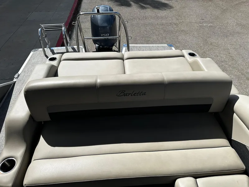 Slide: The Image of 2021 Barletta C22U boat with beige seating and a 150 HP outboard motor. - 16