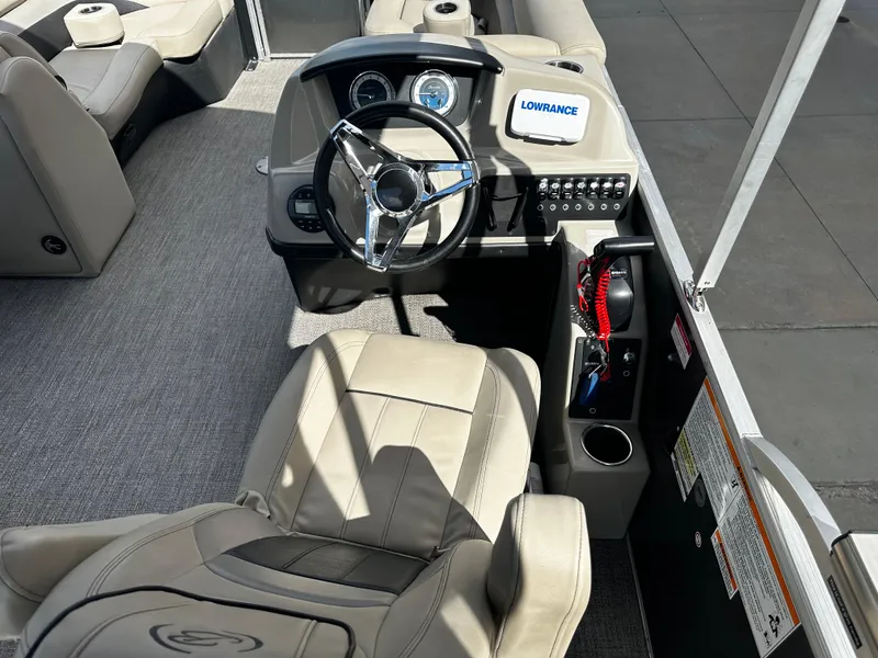 Slide: The Image of 2021 Barletta C22U boat interior with steering wheel and control panel. - 21