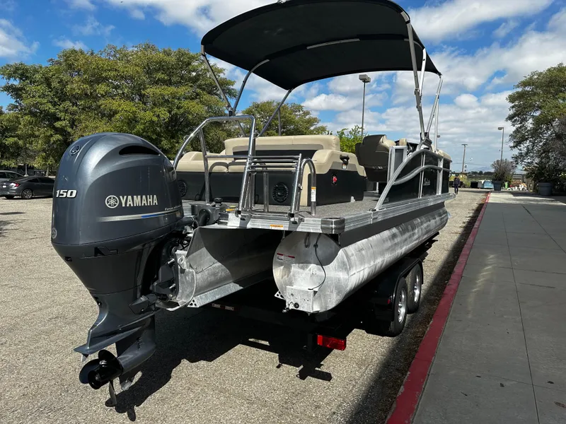 Slide: The Image of 2021 Barletta C22U pontoon boat with Yamaha 150 engine on trailer. - 4