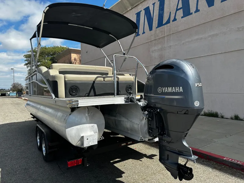 Slide: The Image of 2021 Barletta C22U pontoon boat with Yamaha 150 outboard motor on trailer. - 6