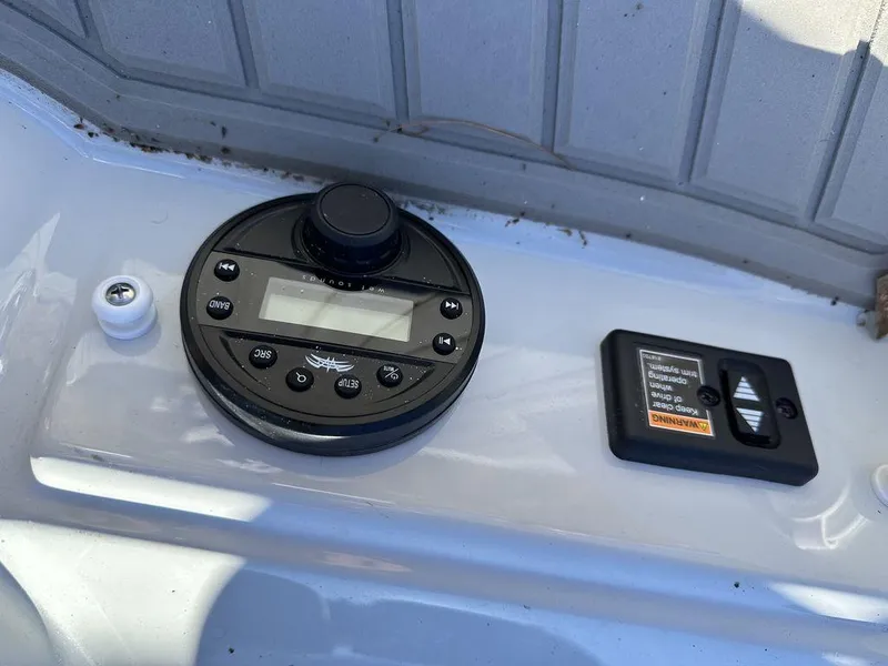 Slide: The Image of Control panel of 2024 Crownline E Series E255 boat with digital display and switches. - 11