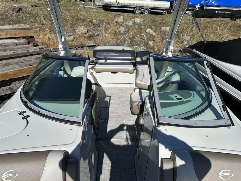 Slide: The Image of 2024 Crownline E Series E255 boat interior with seating and windshield. - 4