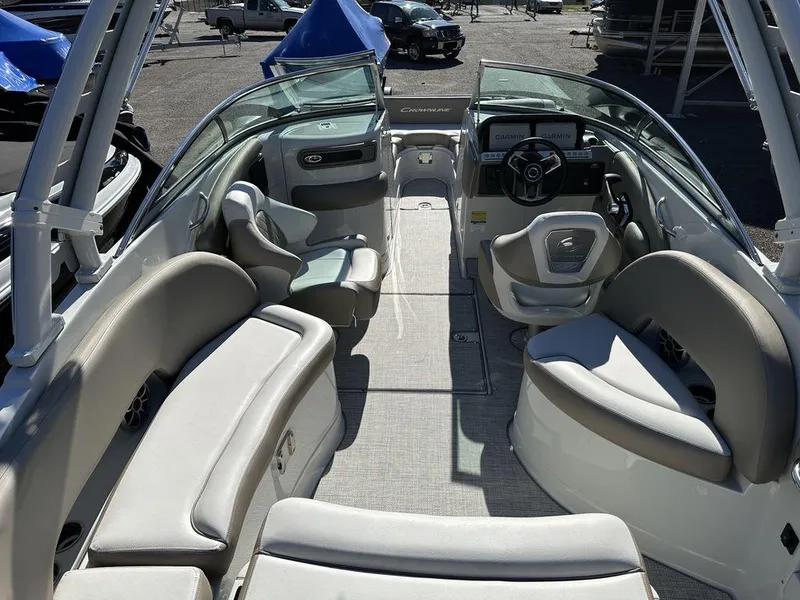 Slide: The Image of 2024 Crownline E Series E255 boat interior with spacious seating and modern dashboard. - 5