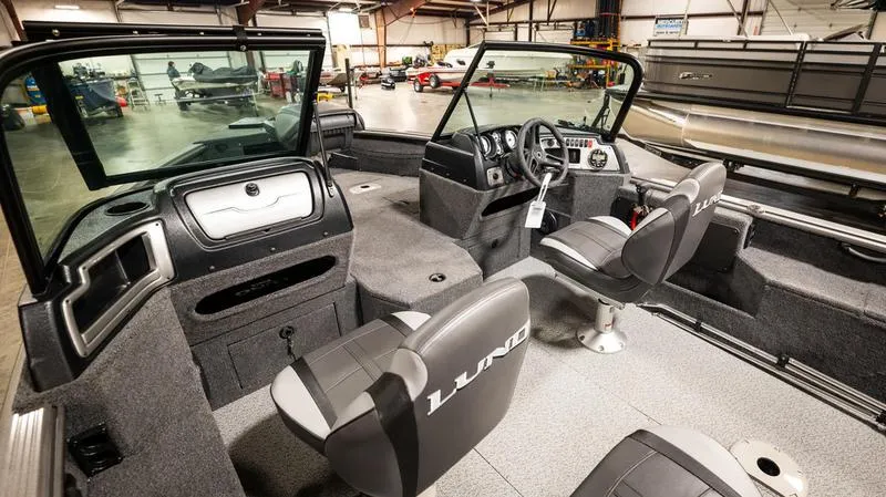 Slide: The Image of 2024 Lund 1875 Impact XS Sport interior, featuring dual seats and a spacious cockpit. - 13