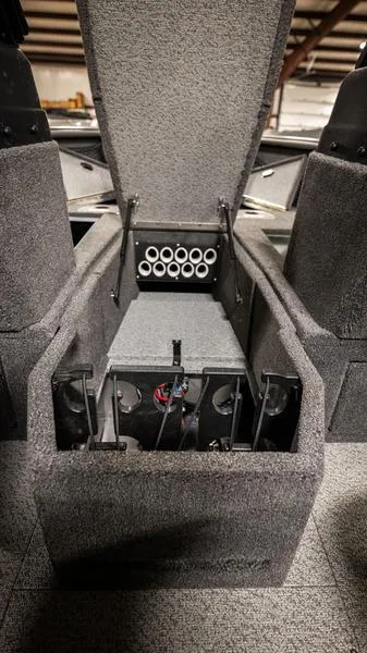 Slide: The Image of 2024 Lund 1875 Impact XS Sport interior storage compartment with rod holders. - 16