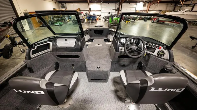 Slide: The Image of Interior of 2024 Lund 1875 Impact XS Sport boat in a warehouse. - 18