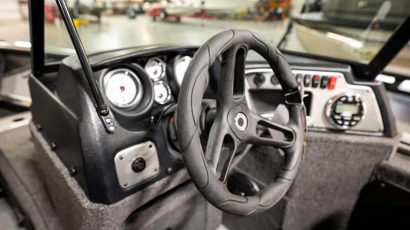 Slide: The Image of 2024 Lund 1875 Impact XS Sport boat dashboard and steering wheel. - 19