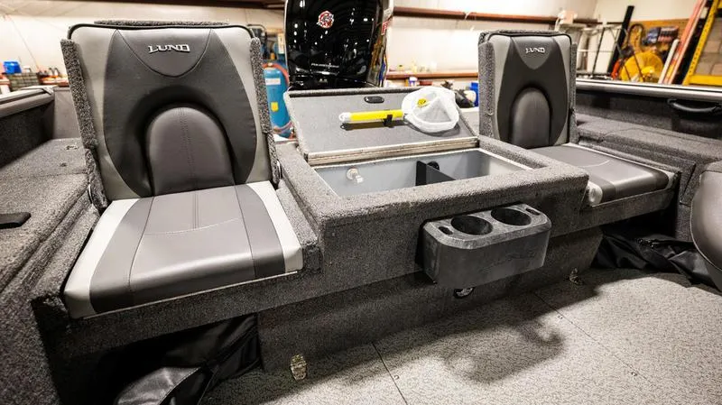 Slide: The Image of 2024 Lund 1875 Impact XS Sport boat interior with seating and storage. - 2