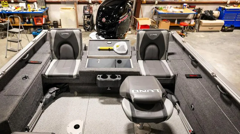 Slide: The Image of 2024 Lund 1875 Impact XS Sport boat interior with seating and storage compartments. - 24