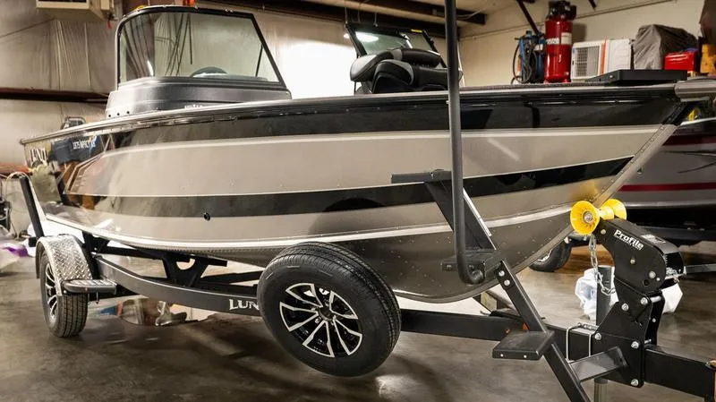 Slide: The Image of 2024 Lund 1875 Impact XS Sport boat on trailer in a garage. - 26