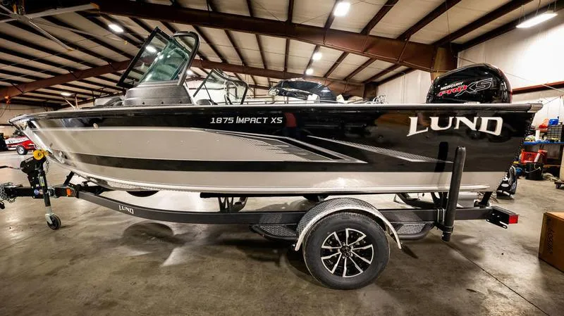 Slide: The Image of 2024 Lund 1875 Impact XS Sport boat in a warehouse. - 4