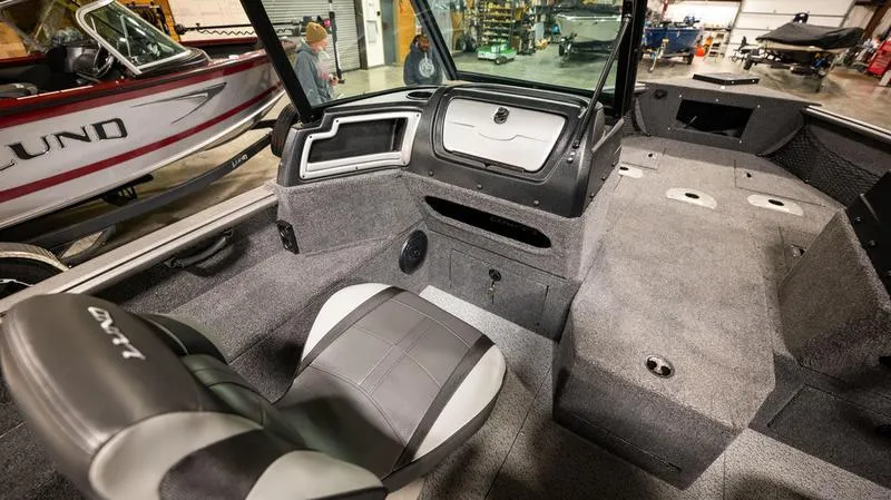 Slide: The Image of Interior of a 2024 Lund 1875 Impact XS Sport boat with seating and storage. - 6