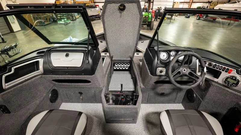 Slide: The Image of 2024 Lund 1875 Impact XS Sport interior, featuring steering wheel, dashboard, and seating. - 7