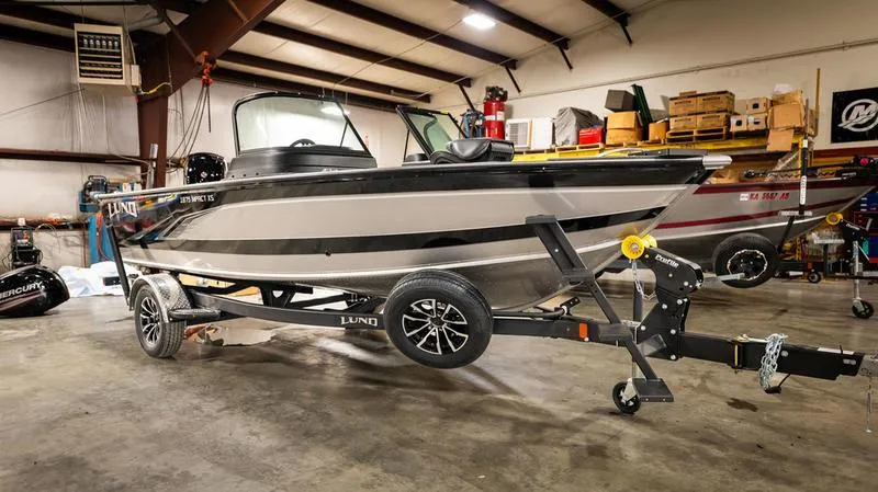 Slide: The Image of 2024 Lund 1875 Impact XS Sport boat in a warehouse on a trailer. - 9