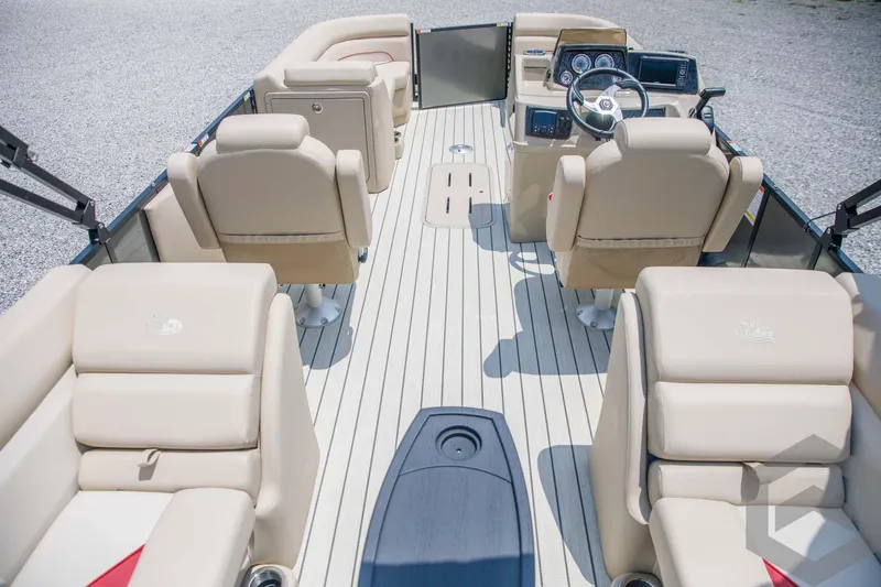 Slide: The Image of 2023 SunCatcher Select 322RC pontoon boat interior with beige seating and modern dashboard. - 21