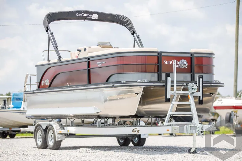 Slide: The Image of 2023 SunCatcher Select 322RC pontoon boat on a trailer. - 3