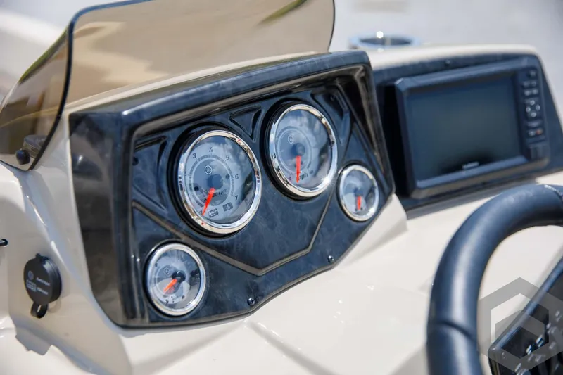 Slide: The Image of Close-up of 2023 SunCatcher Select 322RC boat dashboard with gauges and display. - 32