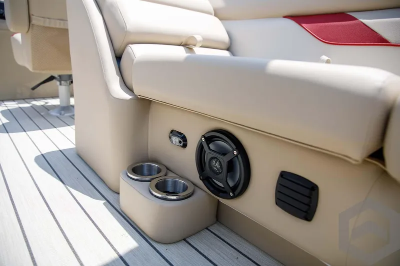 Slide: The Image of 2023 SunCatcher Select 322RC boat interior with cup holders and speaker. - 41