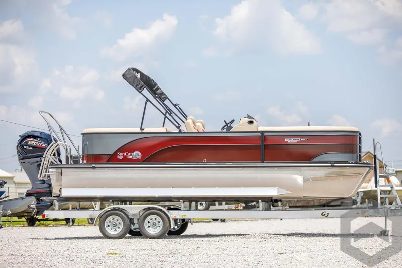 Slide: The Image of 2023 SunCatcher Select 322RC pontoon boat on a trailer under a blue sky. - 5