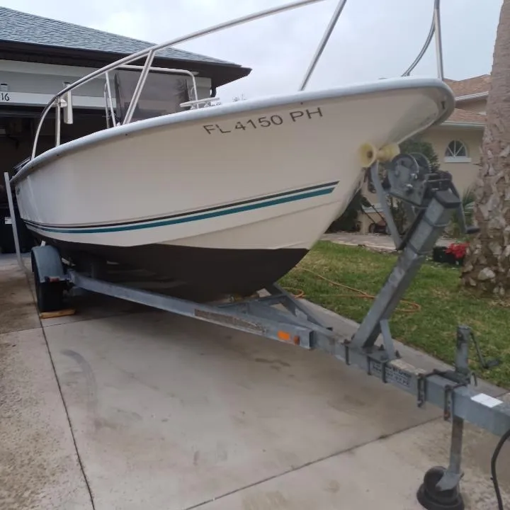 Slide: The Image of 2011 Key Largo 20' Center Console boat on trailer in driveway. - 1