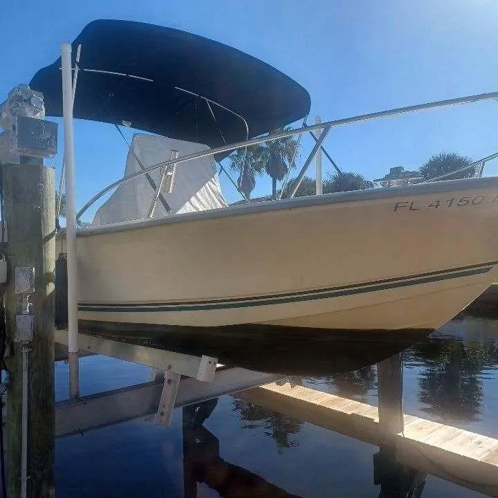 Slide: The Image of 2011 Key Largo 20' Center Console boat on a lift with a black canopy. - 6
