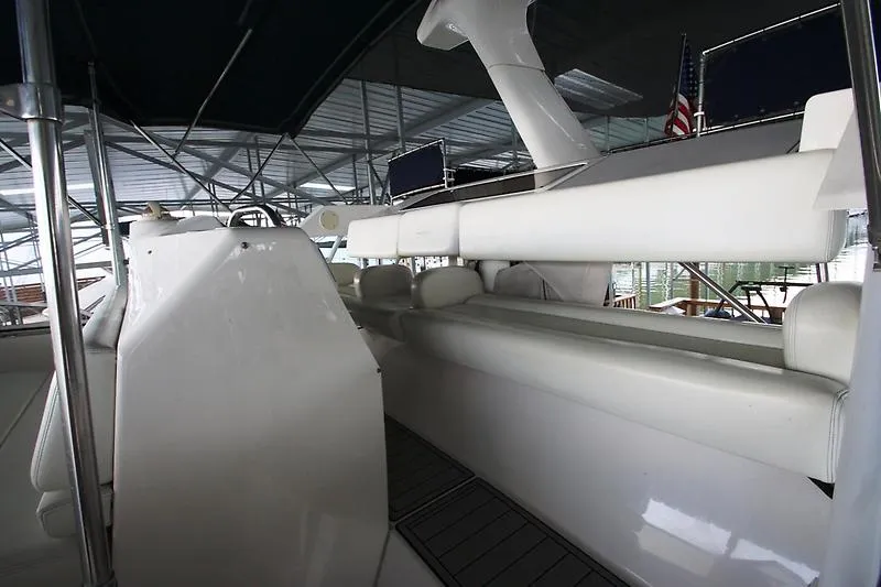 Slide: The Image of 1999 Silverton 392 Motor Yacht interior with white seating and helm station. - 10