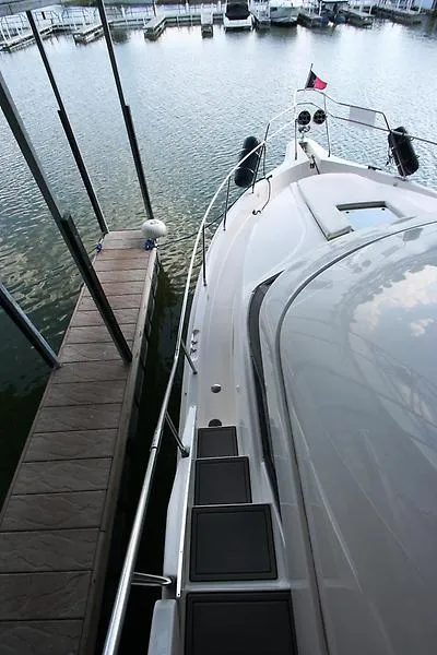 Slide: The Image of 1999 Silverton 392 Motor Yacht docked at a marina. - 12