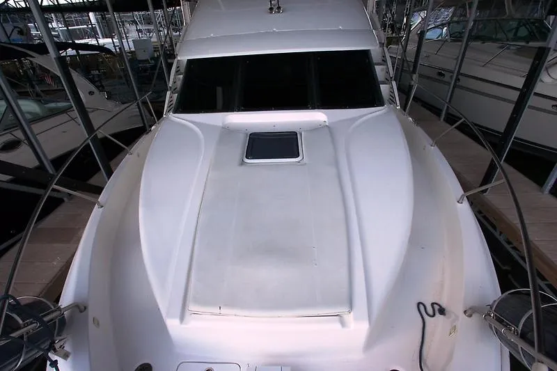 Slide: The Image of 1999 Silverton 392 Motor Yacht docked in a marina. - 13