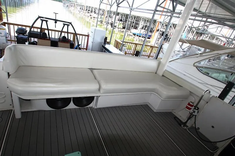 Slide: The Image of 1999 Silverton 392 Motor Yacht interior with white seating and dock view. - 18