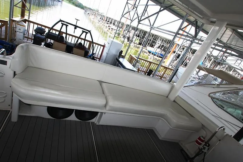 Slide: The Image of 1999 Silverton 392 Motor Yacht interior with white seating and dock view. - 19