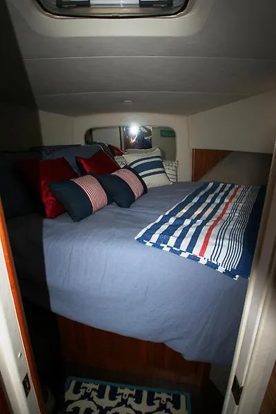 Slide: The Image of Cozy bedroom in 1999 Silverton 392 Motor Yacht with nautical-themed bedding. - 21